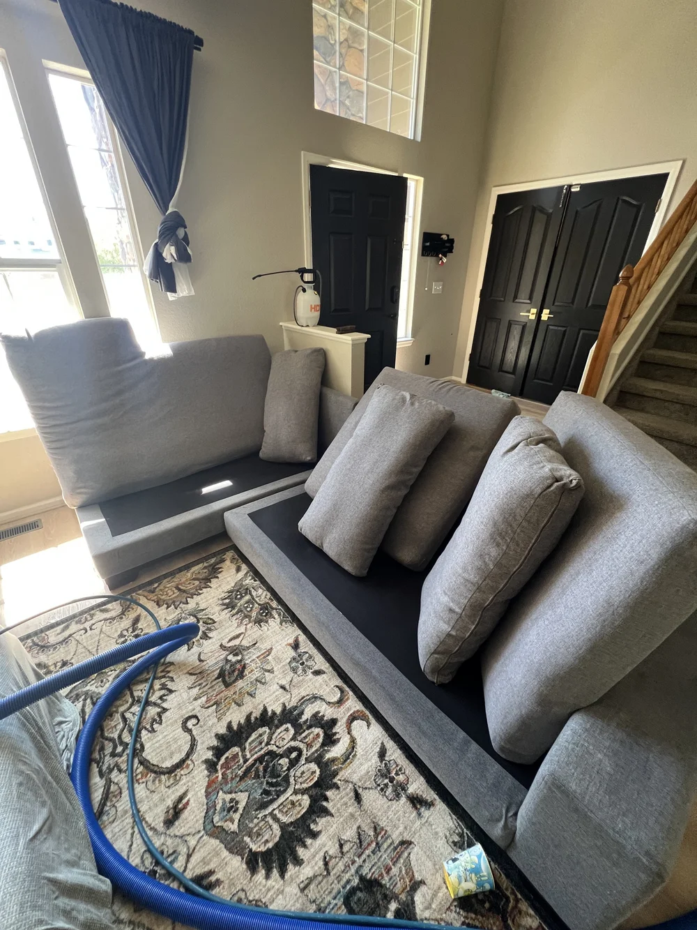 Area rug beside a sectional sofa in a living room